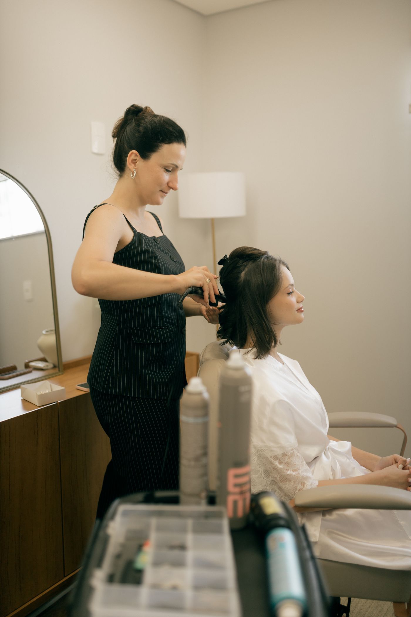 Stylist creating a polished finish for a client